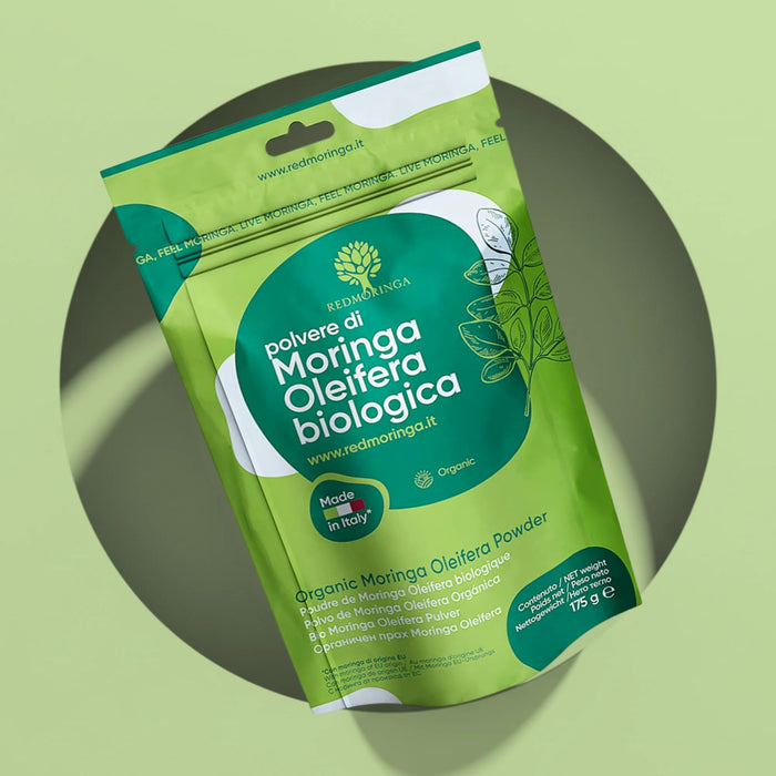 175 g pouch of RedMoringa organic Moringa oleifera leaf powder, packed in Italy, on a green background