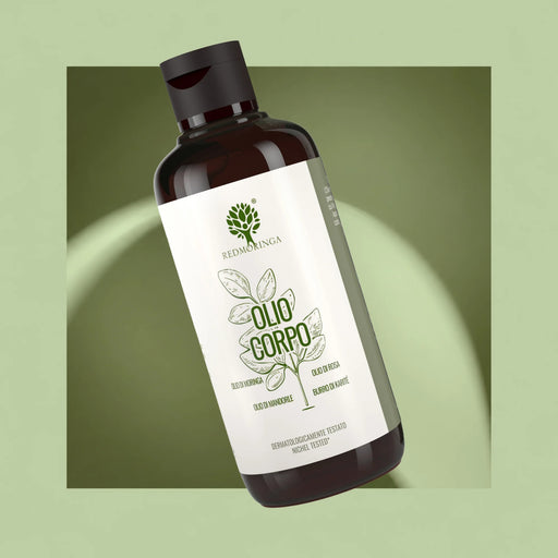 RedMoringa body oil with moringa oil, rose oil, almond oil and shea butter, amber bottle on a green background